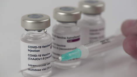 3 covid-19 astrazeneca vaccine vials and syringe to inject medical professionals and people at risk