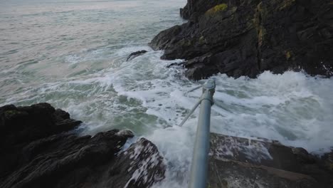 High-tide-crashing-on-rocks-and-staircase