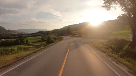 driving a car on a road in norway at dawn