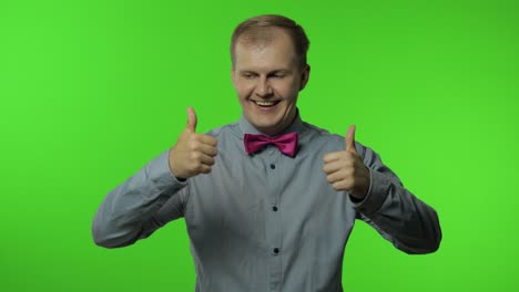 man showing thumbs up sign, smiling, laughing, satisfied with excellent result, good service