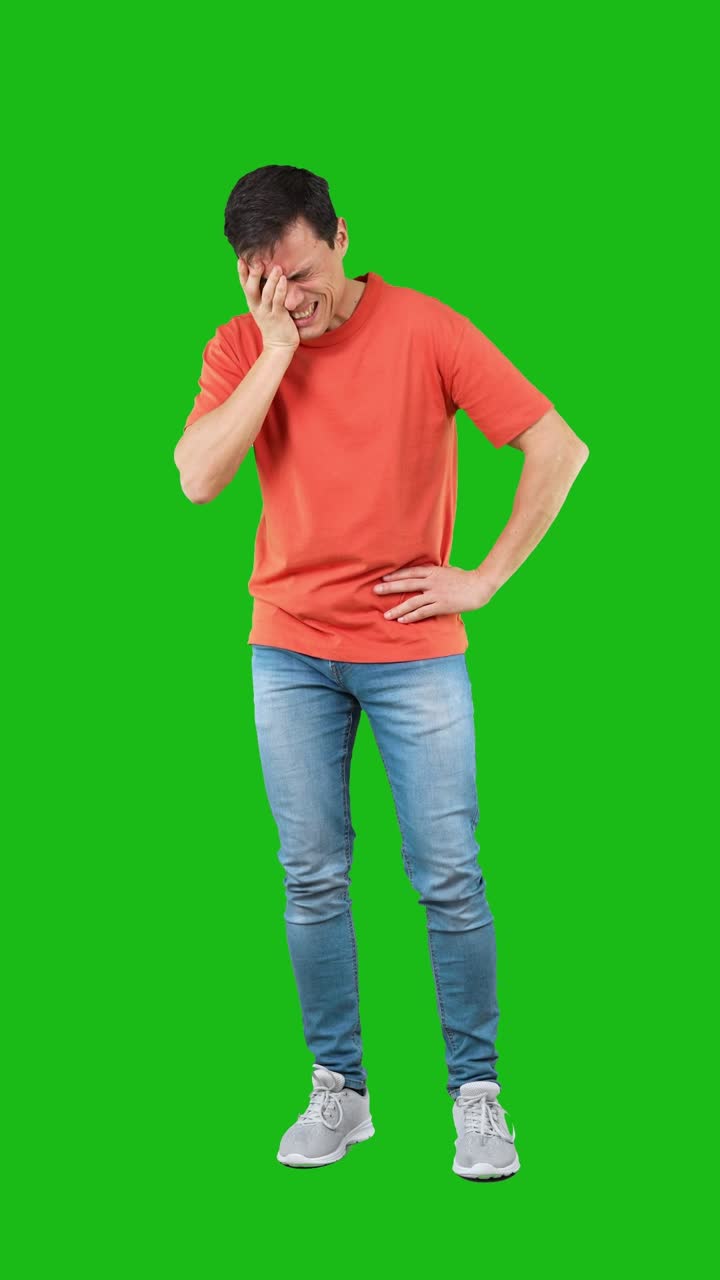 Man suffering from headache or general pain on a green screen