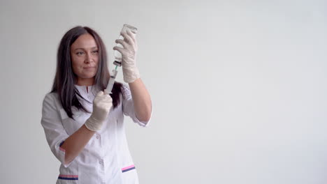 female doctor filling a syringe with a vaccine