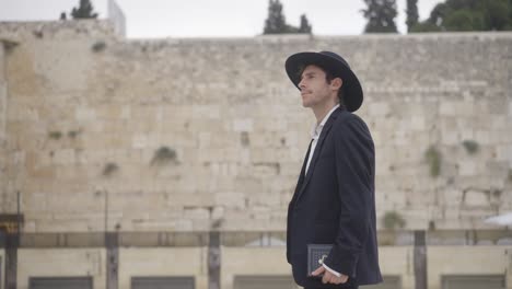 man praying at the western wall in jerusalem
