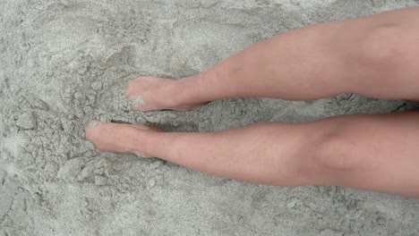 Woman-with-her-feet-in-the-sand