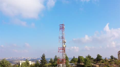 communication towers with cityscape view