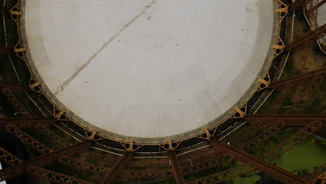 Flying-over-a-decommissioned-victorian-gas-holder-in-London,-England