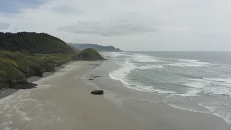 Wide-tracking-drone-shot-of-expansive-beach