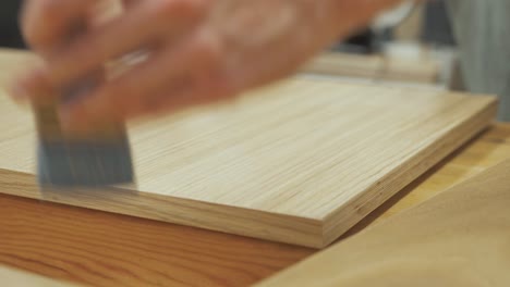 brushing lacquer on oak veneer plywood close up