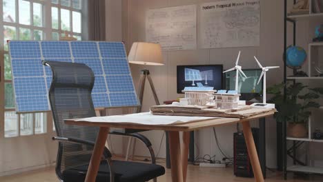 the office that has solar cell next to the model small house with solar panel and wind turbine on the table