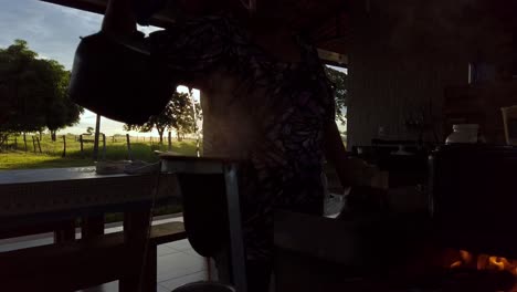 Silhouette-of-a-person-making-coffee-for-a-break-on-the-farm