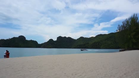 couple watch boat passing at tanjung rhu beach langkawi