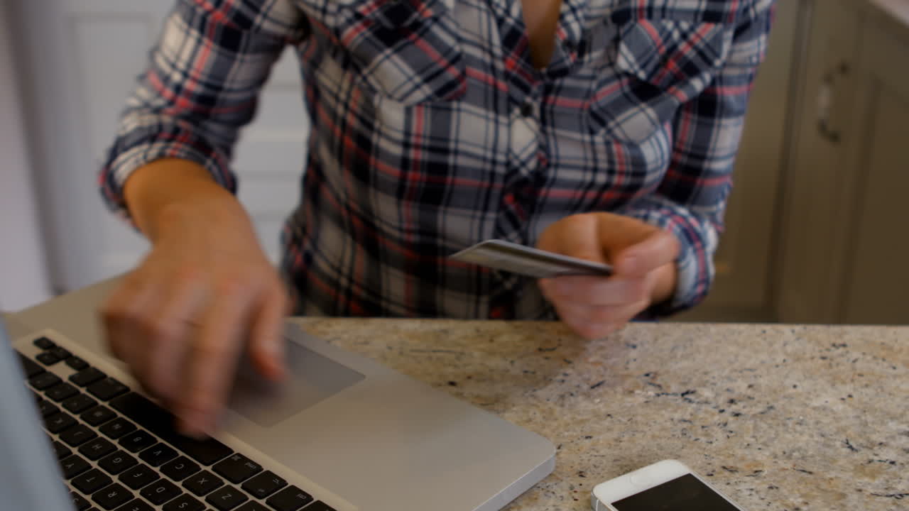 mujer usando el teléfono y la computadora portátil