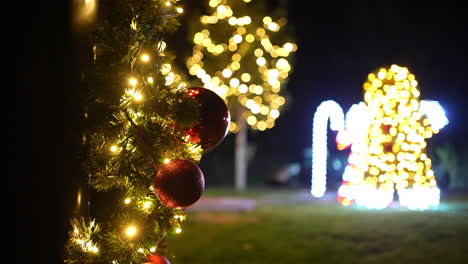 christmas tree with ornaments and lights at night
