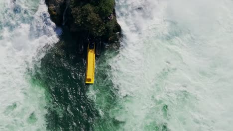 exciting drone footage of a yellow boat near the powerful rhine falls