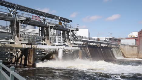 River-flowing-through-dam-with-some-ice-on-dam