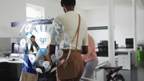 animation of globe of lightbulbs over diverse business people with bicycle greeting in office