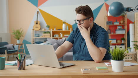 man working on laptop at home