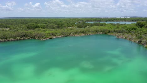 aerial circling of blue lake in cap cana