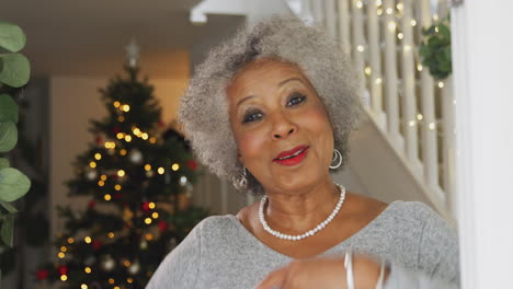 Portrait-Of-Grandmother-Opening-Front-Door-And-Greeting-Family-On-Christmas-Morning