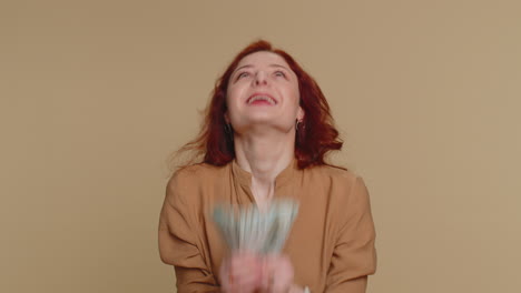 happy woman holding a fan of money