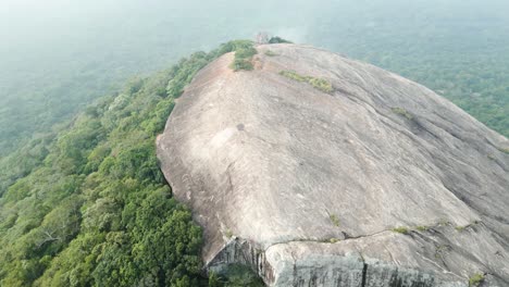 aerial birds eye shot of famous sigiriya pidurangala rock during foggy day in sri lanka