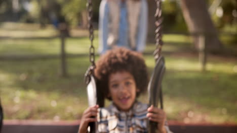Boy on a swing in the park