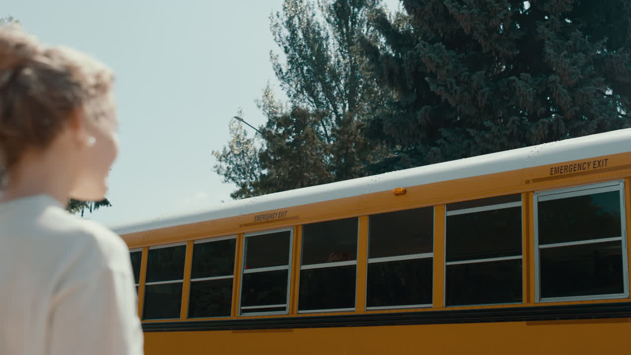Woman waving smiling African American schoolgirl. Joyful mom saying goodbye.