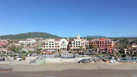 Aerial-Drone-Over-Ocean-To-Oceanfront-Hacienda-Del-Mar-Los-Cabos-Resort-Villas,-Mexico