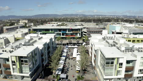 aerial view of a bustling outdoor market in an urban setting