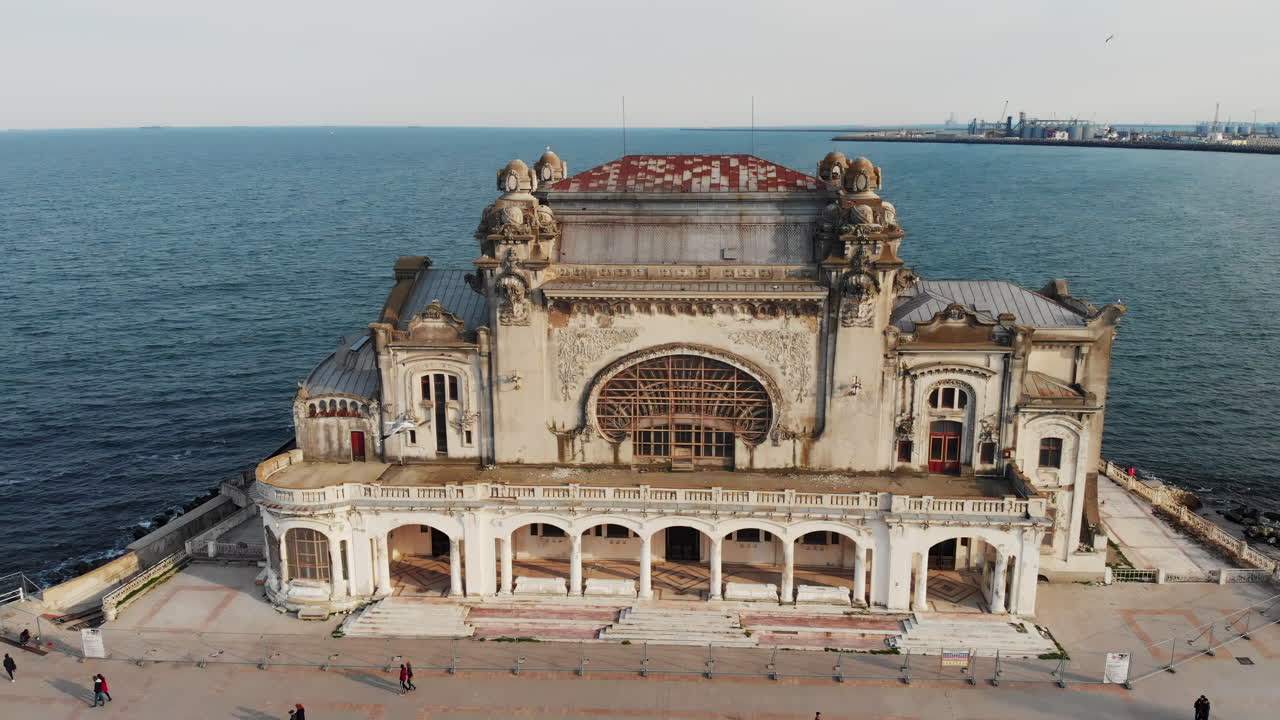 An intriguing look at a historic abandoned building by the sea in Constanta. Explore the intricate architecture and the stories behind its past as visitors wander around the site