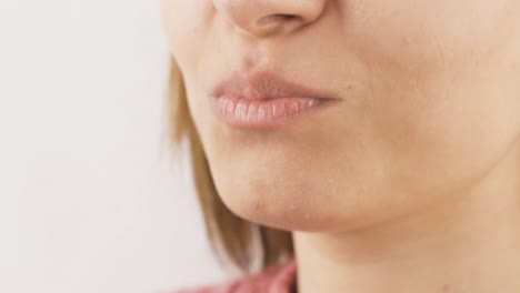 close-up of woman eating jelly beans.