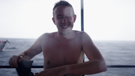 smiling man winking and giving thumbs up in the rain