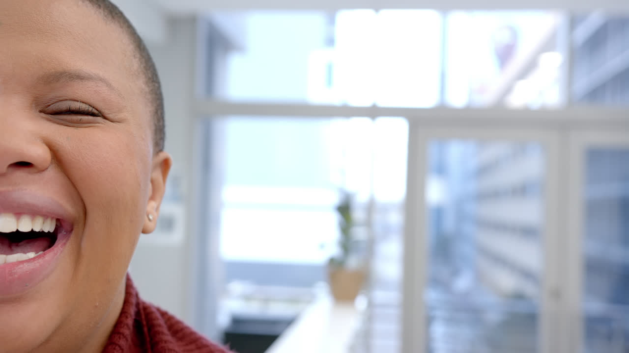 Half portrait of happy african american woman in hospital with copy space, slow motion