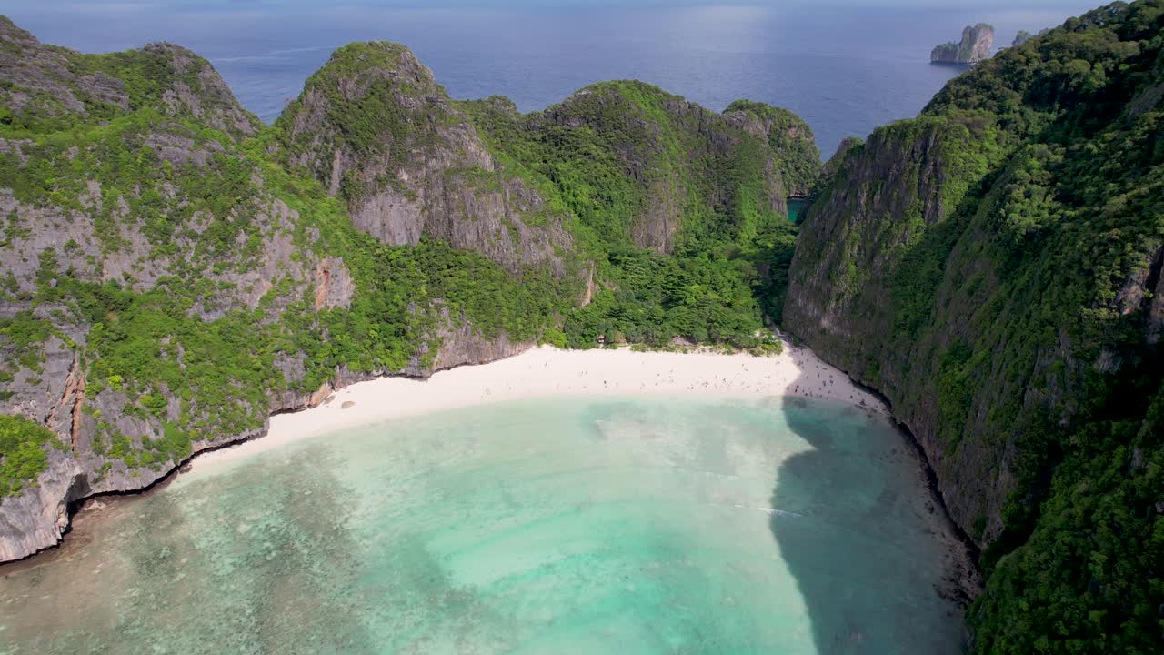 Aerial drone video of Phi Phi Leh with Maya Bay and Pileh Lagoon, Krabi province, Thailand. Aerial top view of amazing tropical island with turquoise water and white beach, famous travel destination.