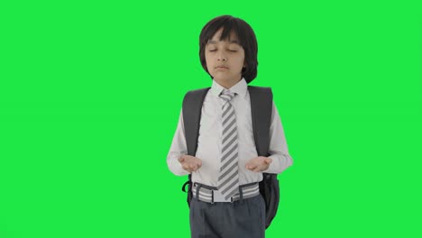 Indian-school-boy-doing-breathe-in-breathe-out-exercise-Green-screen