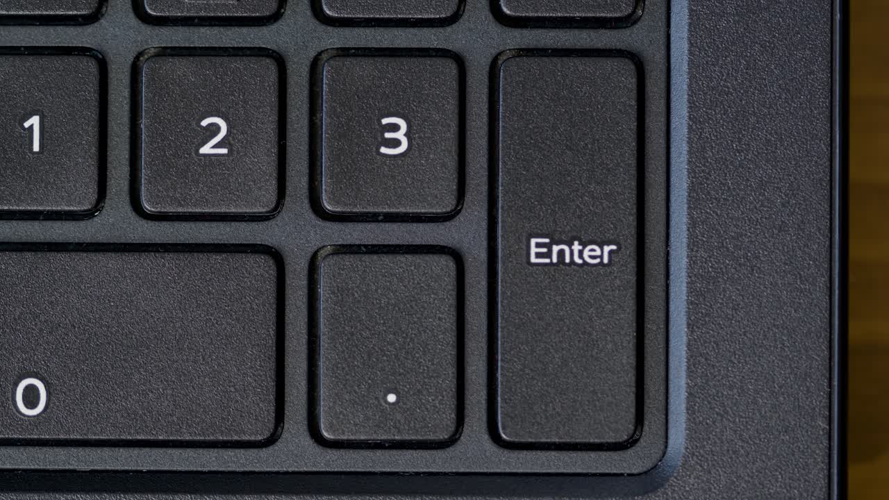 Top View Finger Pressing Enter Keyboard Button