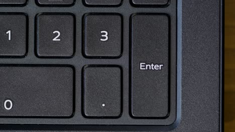 top view finger pressing enter keyboard button