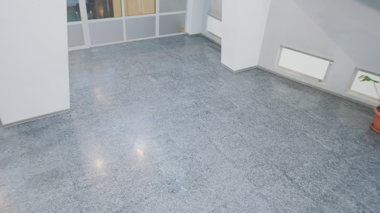 Person walking through a modern building hallway