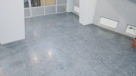 person walking through a modern building hallway