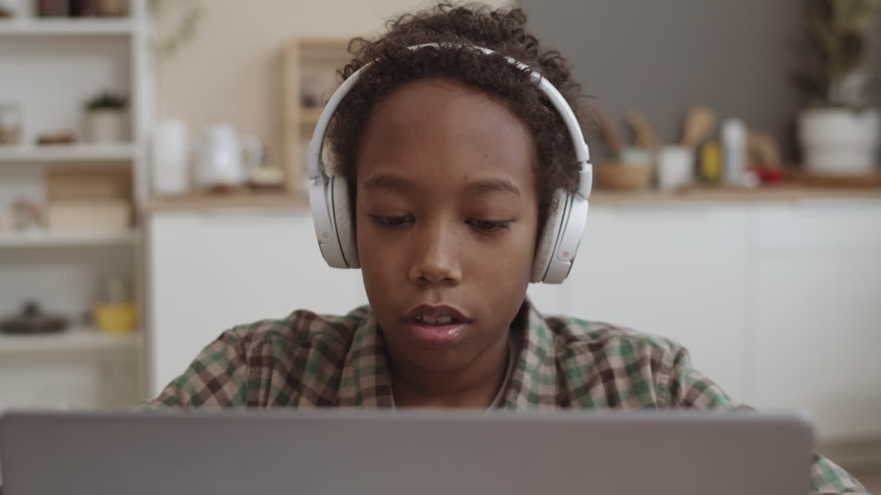 Child Studying on Laptop with Headphones
