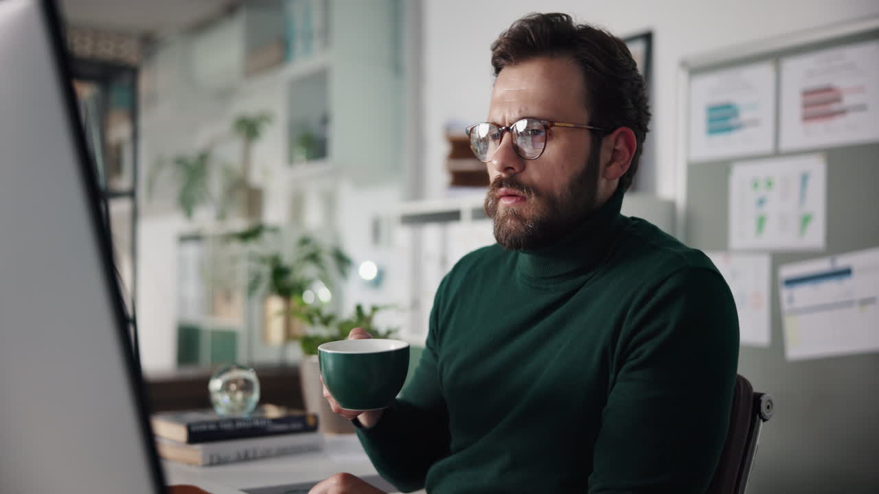 Man Drinking Coffee at Work