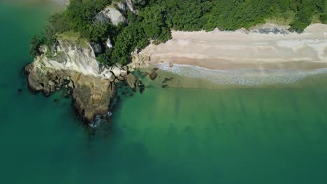 lonely bay on a sunny day with waves crashing against the shoreline