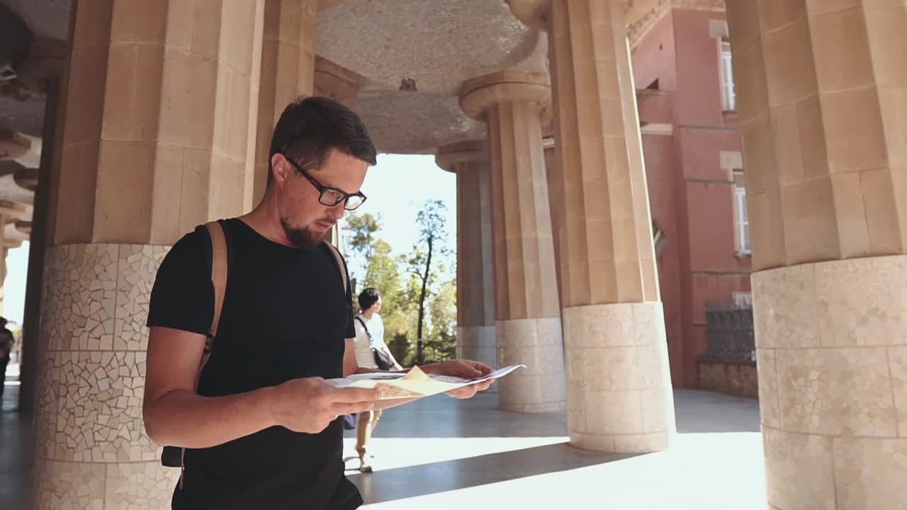 Tourist looking at map in Park Güell, Barcelona