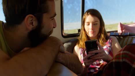 beautiful young woman texting on mobile phone in van 4k