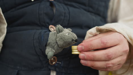 village squire gives lid with elixir to cute toy mouse