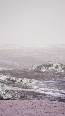 a beautiful, calm beach scene with rocky shores and a misty horizon.