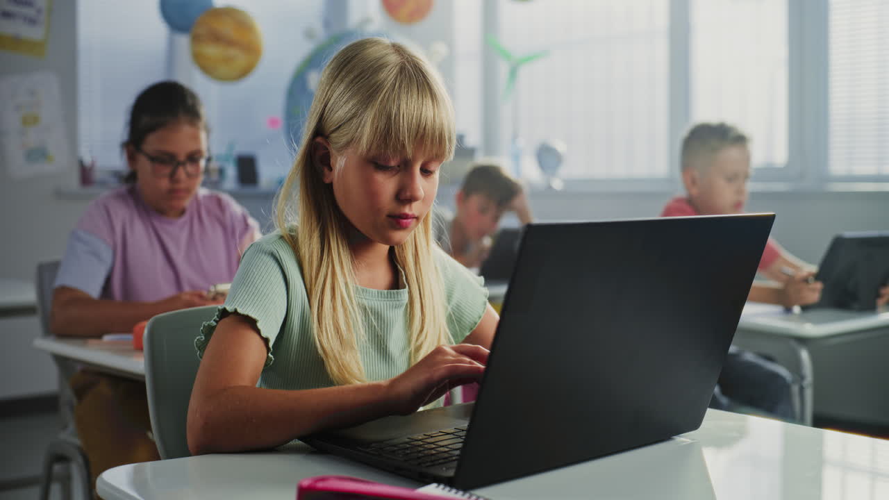 Students learning in the classroom with laptops