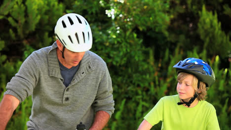 father and son riding bicycles