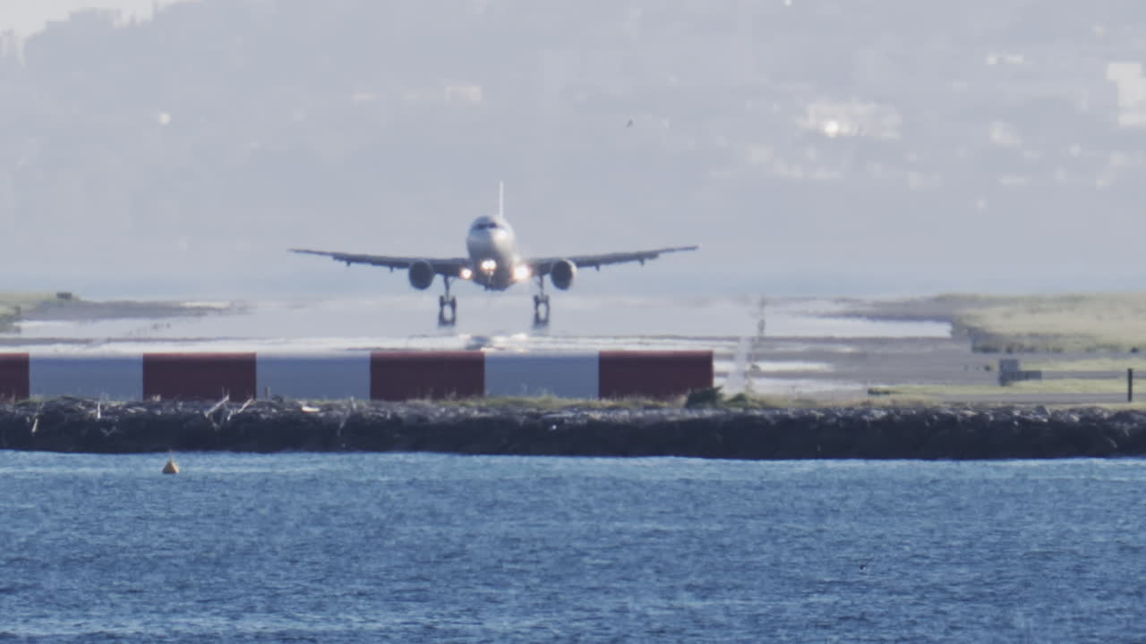 Distant view of airplanes landing at the Nice Cote d'Azur Airport in daylight