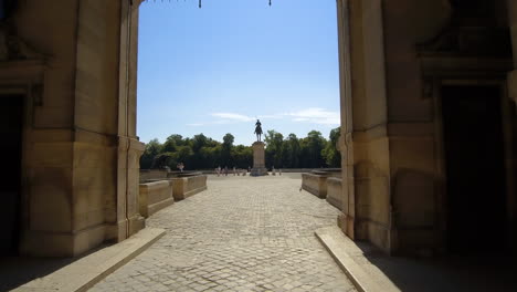 slow motion shot of the chantily castle, his wall and the main entrance, while walking inside.
